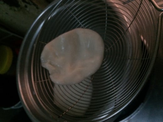 Drop the flattened dough in a pot of boiling water. When it floats, it's done. 