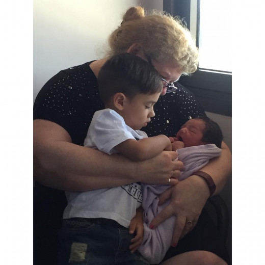 Cyrus being cuddled by proud Granny Kathy and big brother Taidan.