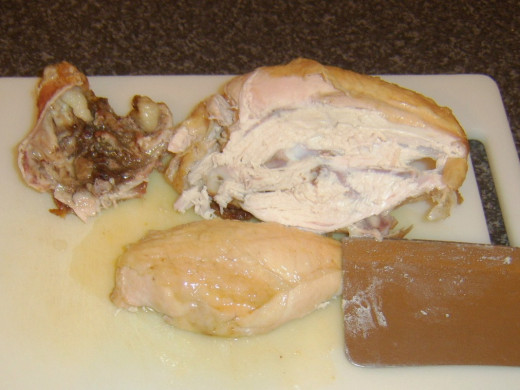 Breast fillets are sliced from the rested chicken