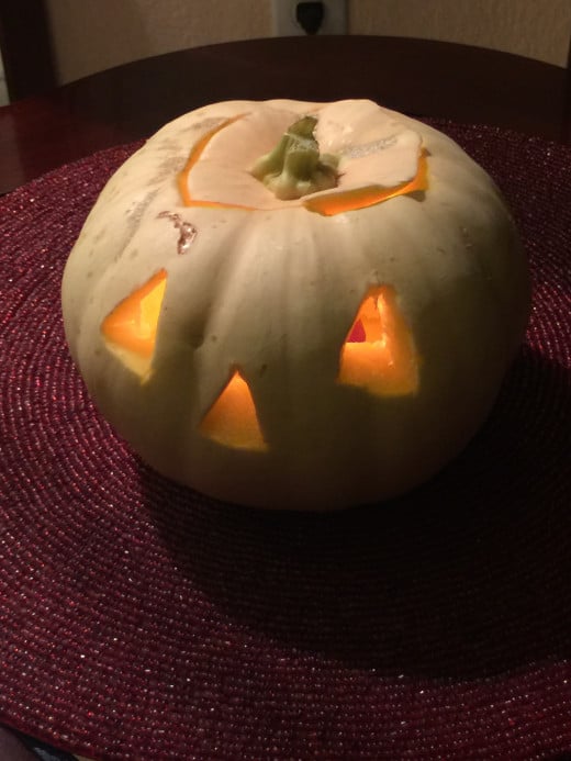 Pumpkins now come in different colors and this Jack-O-Lantern was carved from a white pumpkin