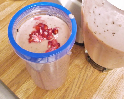 After I pureed the pomegranates, bananas, almond milk, orange juice and chia seeds together, I poured the smoothie into a plastic cup.