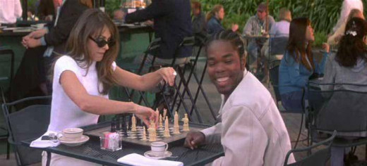 Elisabeth Hurley & Gabriel Casseus playing chess