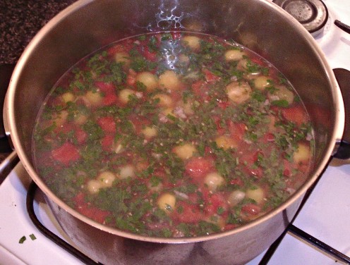 Spicy beef with red, yellow and green tomatoes soup is ready to serve