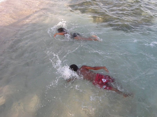 Quincy and Siobhan racing along a private beach in Spotts, Grand Cayman