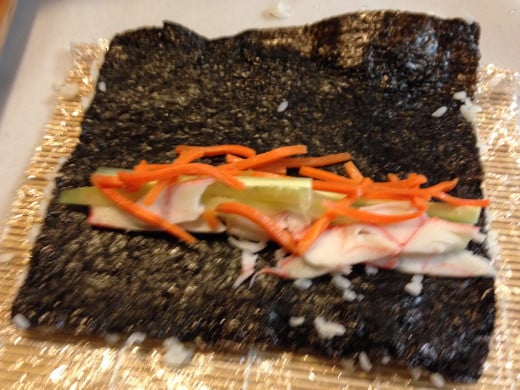 If you plan on making sushi with the rice on the outside you might want to wrap the mat in plastic wrap. It will prevent the rice from sticking to the mat. Not to mention it will make clean up easier. 