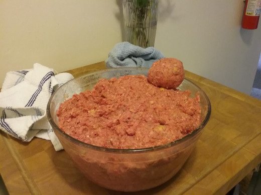 Start gently rolling the balls to the desired size while the oil is heating. Don't over roll the meat or the meatballs will turn out dry and tough.