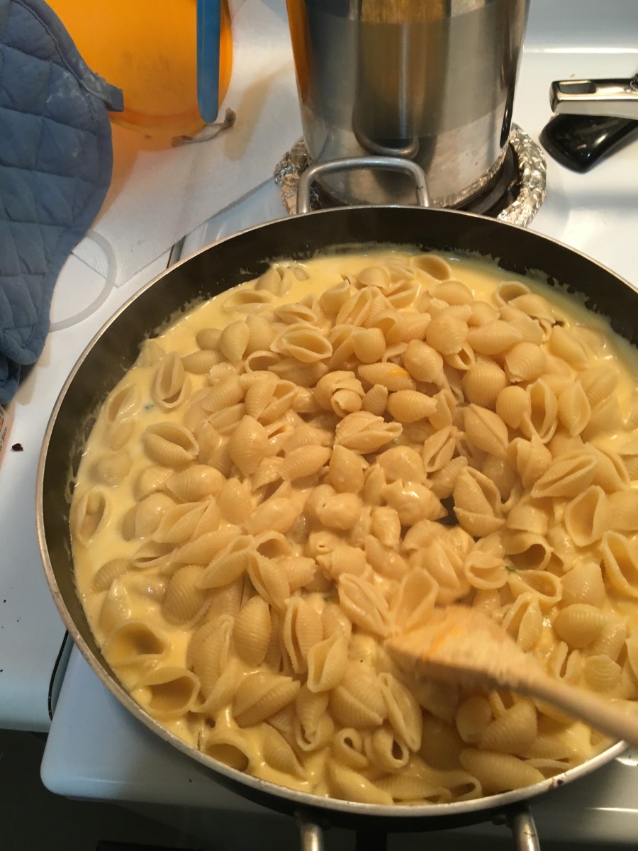 I add the pasta first. That way I get cheese in all of the shells.