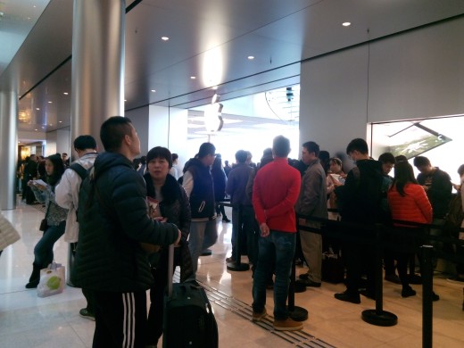 Queues form outside of the Apple Store in IFC Plaza, Hong Kong