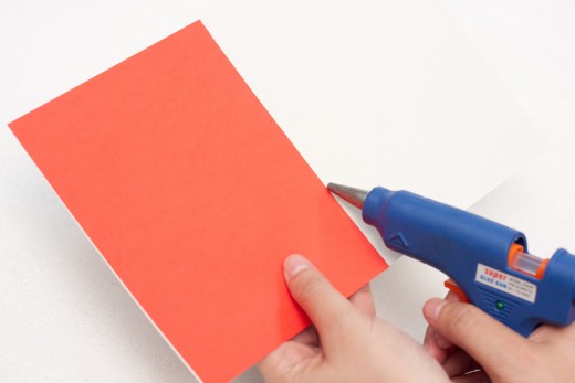 Cut a rectangle out of the red construction paper and glue it inside the card to make your card colorful and bright.