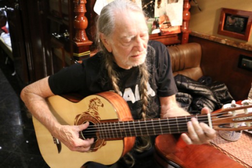 One of the few photos of Willie Nelson you will ever see with him playing a guitar other than trigger.