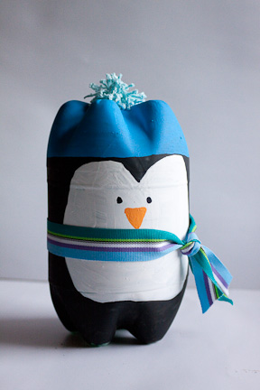 Two soda bottles, some paints, ribbon, and a pompom - plus some glue and patience - are what you need to make this little craft penguin project.