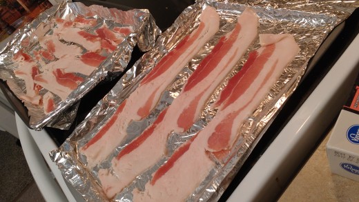 bacon arranged on foil lined baking sheets