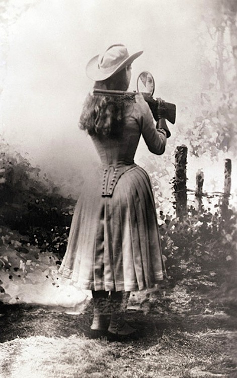 Annie Oakley Shooting Over Her Shoulder with a Handmirror