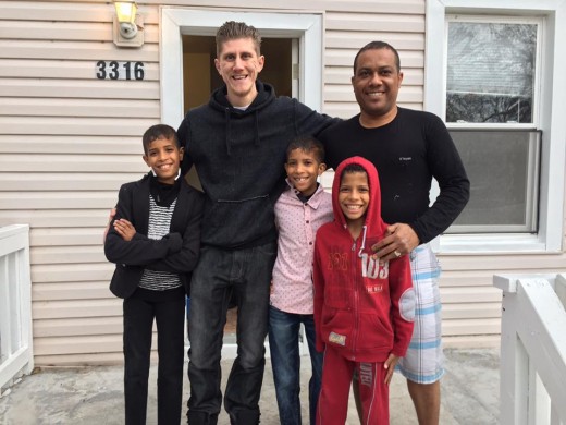 Volunteer Elvis Kuruzovic with a family after he helped deliver necessary items.