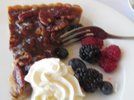A delicious slice of Pecan Pie with whipped cream, black berries and raspberries was served for dessert.  