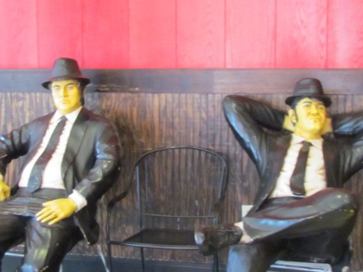 Statues of the Blues Brothers, rests on the bench outside of Fridays, as part of the Rainforest experience.