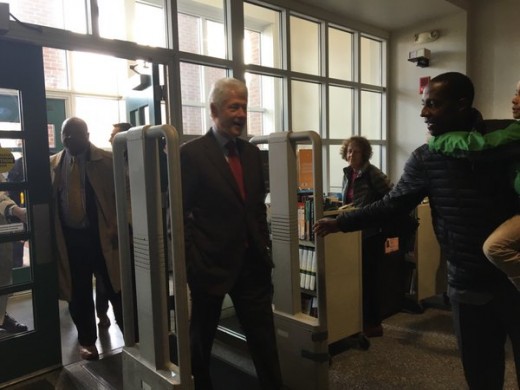 Clinton walking into MA polling station during voting hours.