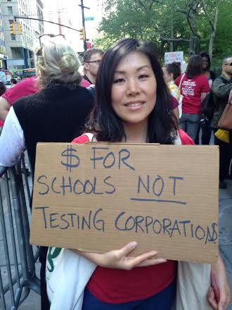 Jia Lee, teacher  in New York City's  Earth School protests  monies given to testing  corporations not schools.