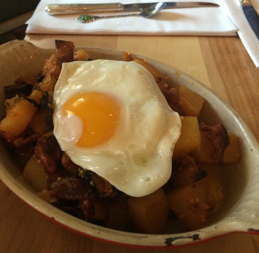 Mallard Cottage's Hash Skillet - roasted root vegetables, topped with house-made pastrami, honey mustard sauce and a sunny-side up fried egg!