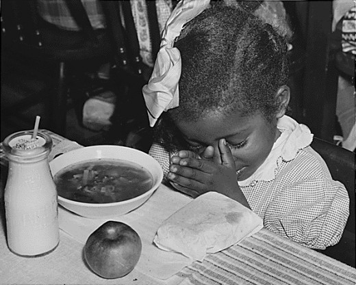 Photo of a young girl receiving a school-provided lunch in 1936
