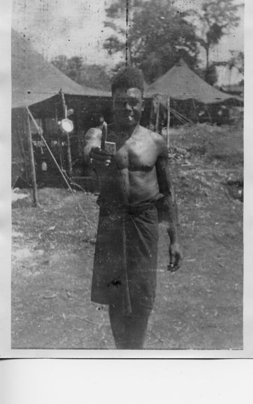 New Guinea native smoking cigarette while visiting U.S. Army camp in WW II  