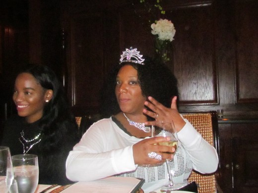 Chante, wore a crown during our family dinner on Friday evening for the first event of her bridal shower weekend. Her daughter LaShae, smiles at the joking of her mother's elegance.