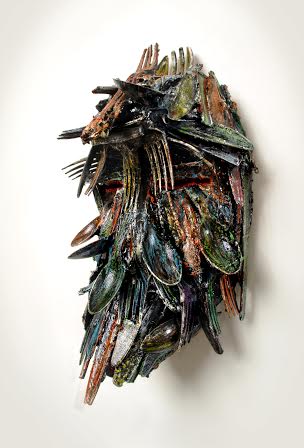 "African Mask"; Plastic forks, spoons, knives and paint; 12.5in x 9in x 9in.