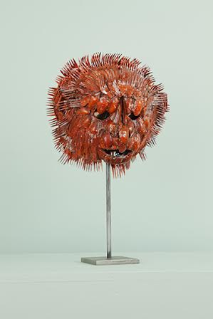 "Lion Head"; Plastic forks, spoons, knives, paint and mirror; 21in x 11in x 8in.
