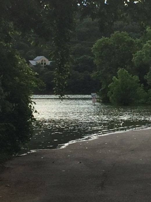 The boat ramp is under water and the parking lot is flooding.