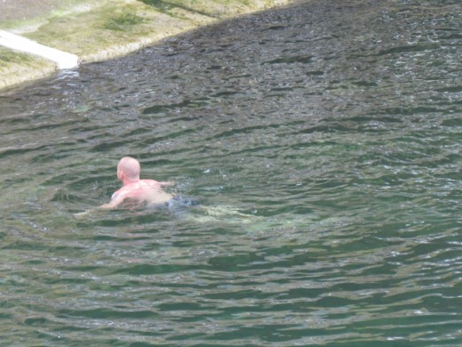 A man was swimming near the pier in Marseille, France.