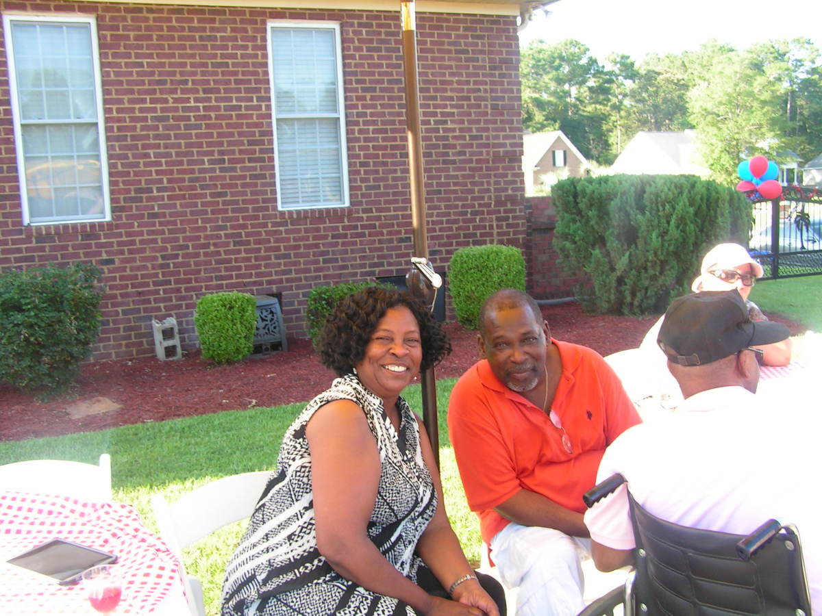Deborah and her husband enjoy the barbeque and pool party at Ann and David's house on Friday with their classmates.