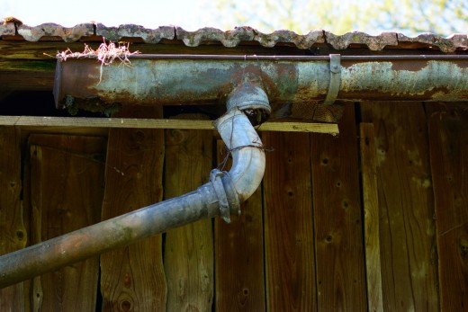 Broken roof gutter needing repair.