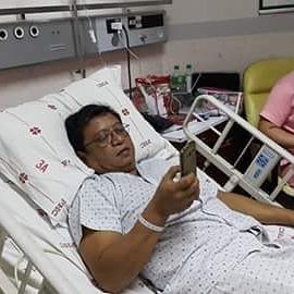 Dad texting family members before undergoing angioplasty for his heart.