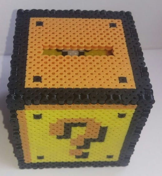 A Mario Coin Block Money box made from Perler Beads! So cool and very cleverly made.