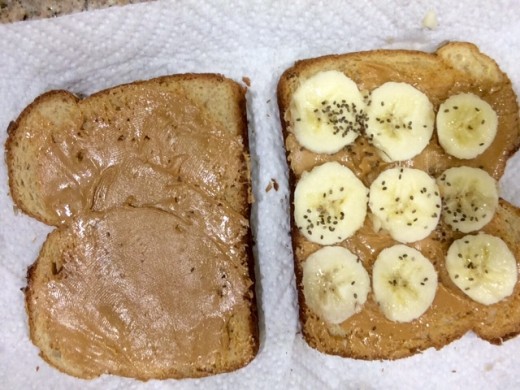 Breakfast with a peanut butter sandwich, banana, and Chia seeds sprinkled on top