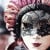 A young girl wearing a venetian mask. A young girl wearing a venetian mask.