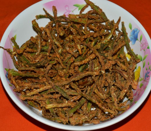 Step two: Drop a bunch of them in medium hot oil. Fry them until they are crispy and golden brown. Repeat the same with the remaining okra strips. Kur Kure okra (crispy bhindi chips) or spicy fried okra is ready! 