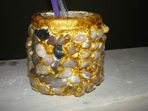 A Pencil holder decorated with ornamental stones.