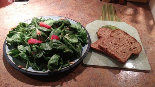 A delicious spinach salad with fresh strawberries tossed with sunflower seeds and crumbled goat cheese. Drizzle a little strawberry - virgin olive oil to add flavor to the spinach leaves.