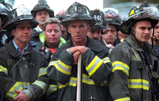  Firefighters look on Friday, Sept. 14, 2001, as President George W. Bush surveys the destruction left by terrorist attacks on New York City on 9-1-1.