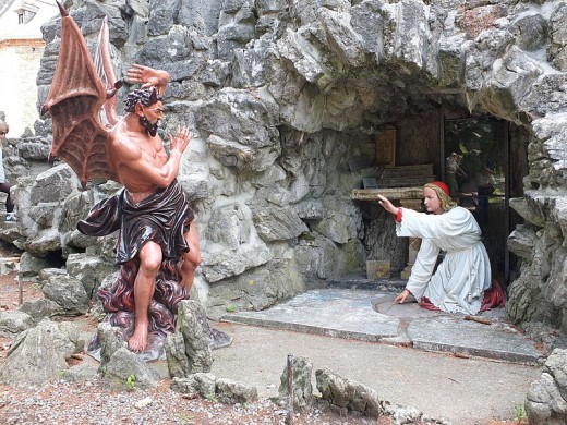 Statue The Temptation of St Anthony in Saint Anthony's Cave (1903) in Crupet, Assesse, Namur, Belgium.