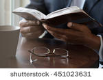  Pastor studying Bible for inspiration for his next sermon