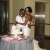 Darlena and Raymond, gather before the cutting of their cake.