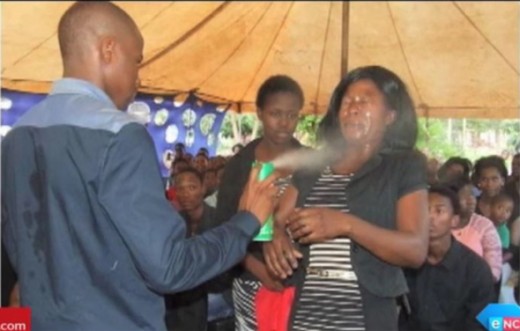 Screengrab/eNCA News: Pastor Lethebo Rabalago of Mount Zion General Assembly spraying Doom pesticide onto a woman's face 