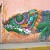 colorfull grafitti of a chameleon on entire pink wall outside the station of tren ligero of Xochimilco
