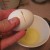 Strike the egg against a sharp edge halfway between the ends of the egg shell or use a knife Strike the egg against a sharp edge halfway between the ends of the egg shell or use a knife
