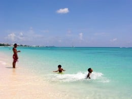 The author's children frolicking in the beautiful waters on Seven Mile Beach, Grand Cayman.