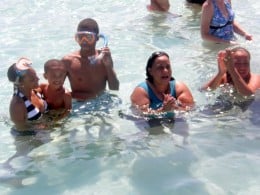 The author with her children, and childhood friends at Sting Ray City, Grand Cayman.