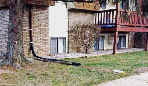 A terribly wrong way to divert stormwater from a downspout: toward a sidewalk.