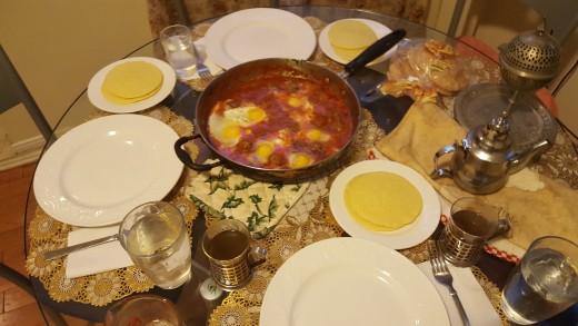 The table set with love , we have Moroccan pancakes with honey, Moroccan tea, and always a glass of water